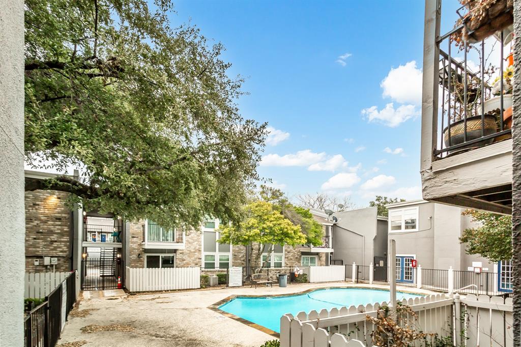 6061 Milton Street, Unit 231 Dallas, TX 75206 - Photo 23 of 27 Charming interior courtyard setting with mature trees, pool views, and a peaceful community atmosphere that adds to the appeal of this East Dallas condo