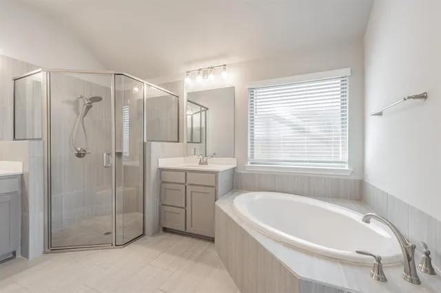 an empty room with chandelier fan and windows