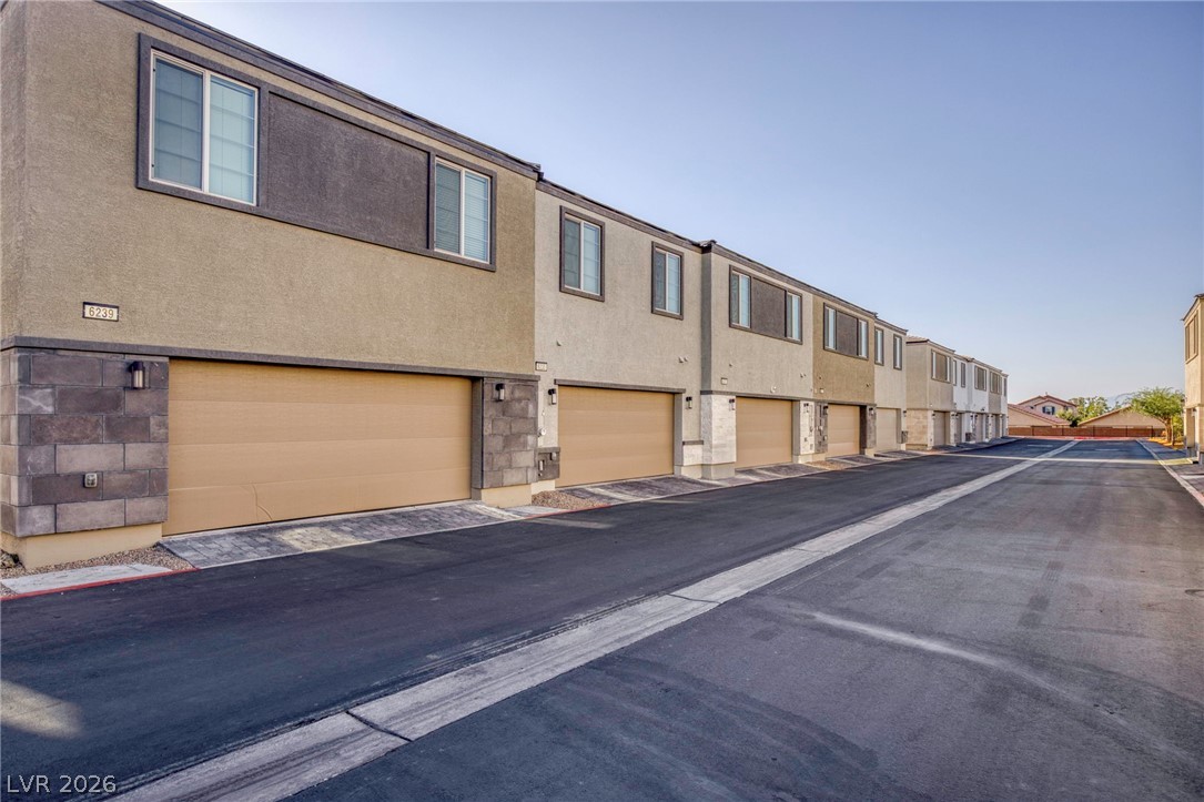 6227 Runestone Street Las Vegas, NV 89113 - Photo 32 of 33 These modern homes feature convenient attached garages and a contemporary exterior design.