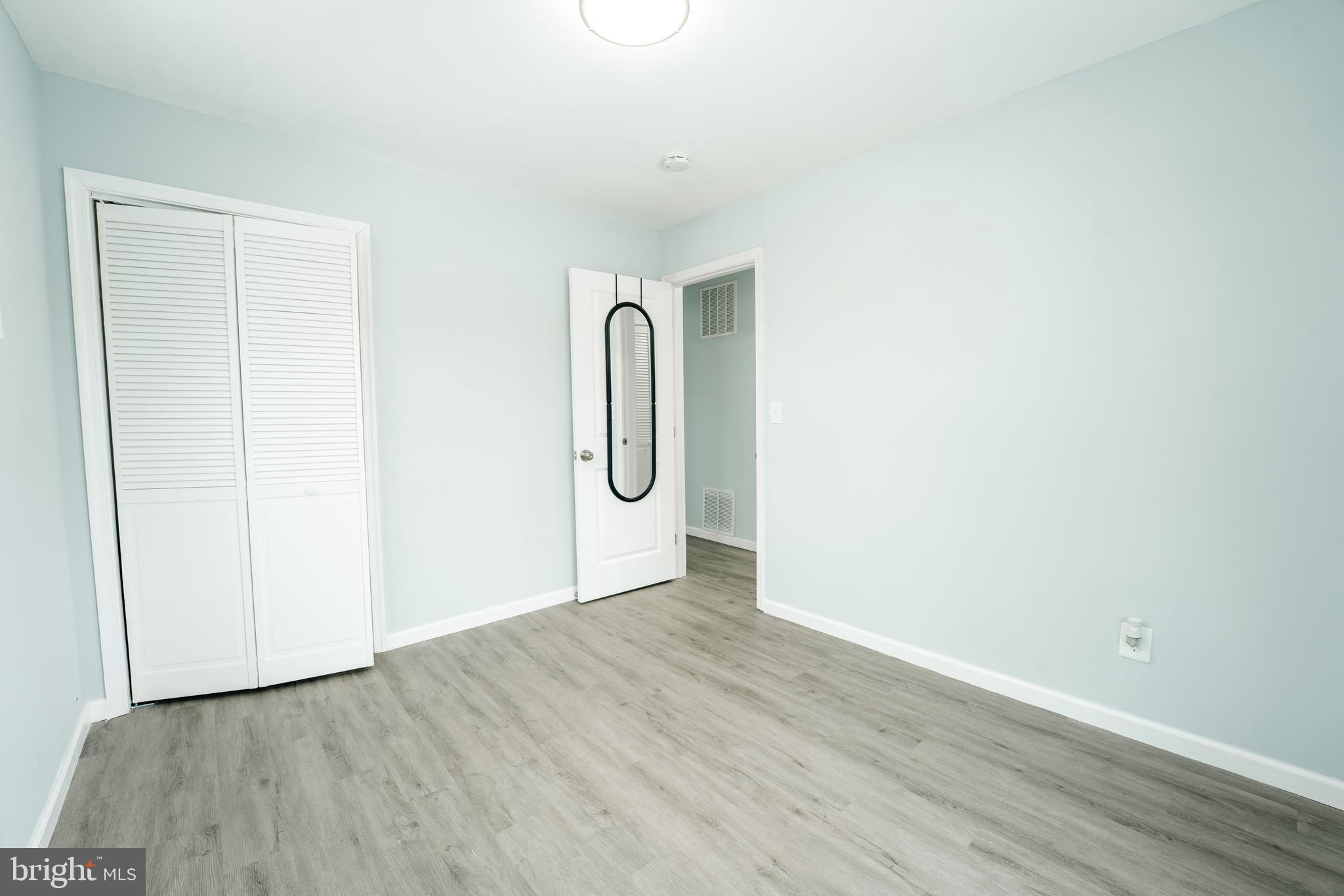 3410 Embry Street Silver Spring, MD 20902 - Photo 22 of 28 a view of a room with wooden floor and white wall