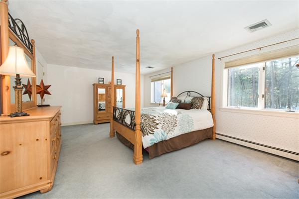 13 West Parish Road Boxford, MA 01921 - Photo 23 of 30 a bed sitting in a spacious bedroom next to a window