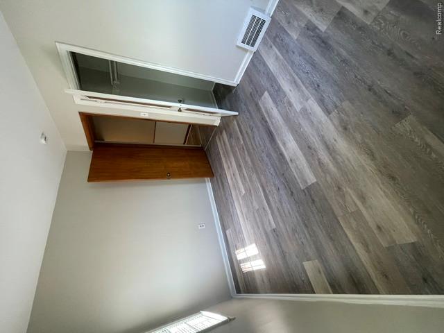 22404 Rausch Avenue Eastpointe, MI 48021 - Photo 7 of 12 Room with wood-finish flooring, light gray wall paint, and white baseboards