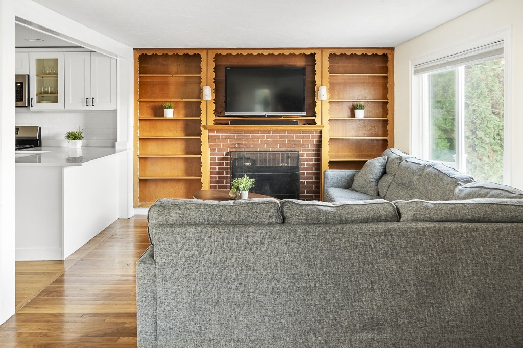 30 Crawford Road Braintree, MA 02184 - Photo 11 of 21 a living room with fireplace furniture and a flat screen tv