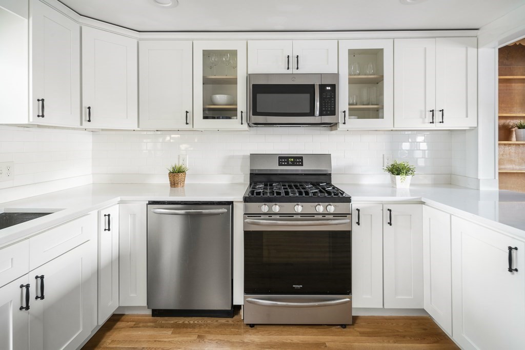 30 Crawford Road Braintree, MA 02184 - Photo 4 of 21 a kitchen with stainless steel appliances granite countertop a stove top oven microwave and cabinets