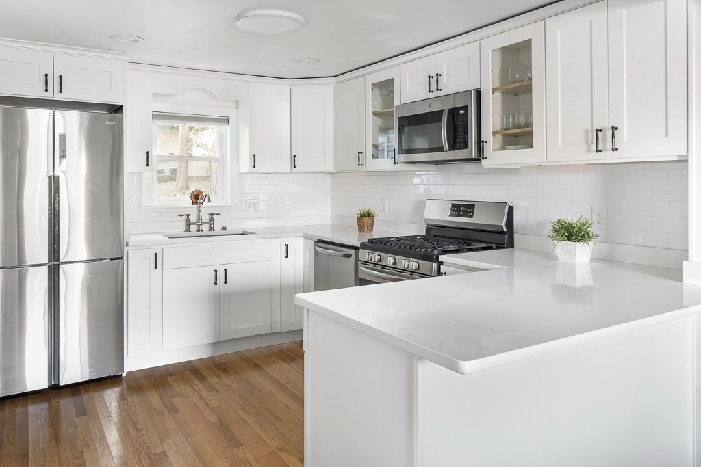 30 Crawford Road Braintree, MA 02184 - Photo 6 of 21 a kitchen with stainless steel appliances granite countertop a refrigerator a stove top oven a sink and cabinets