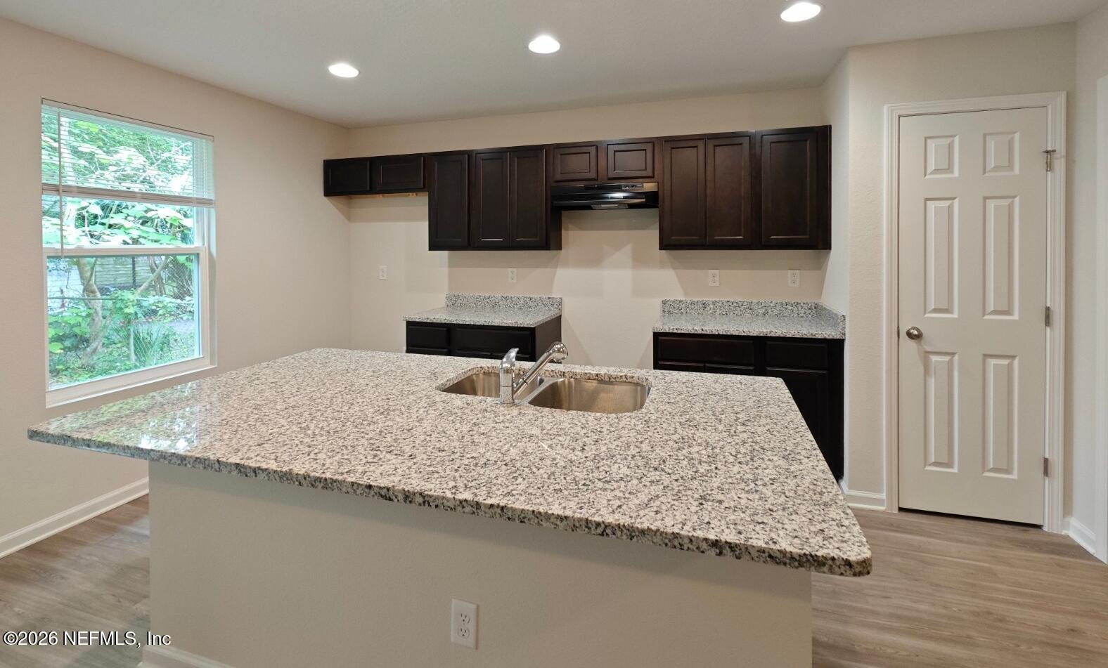 3142 Rosselle Street Jacksonville, FL 32205 - Photo 3 of 7 a kitchen with kitchen island granite countertop a sink and a stove top oven