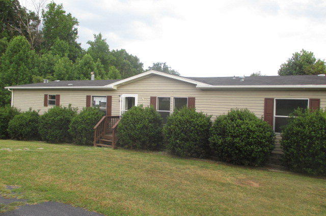 2879 John Baker Road Fieldale, VA 24089 - Photo 1 of 1 a front view of a house with garden