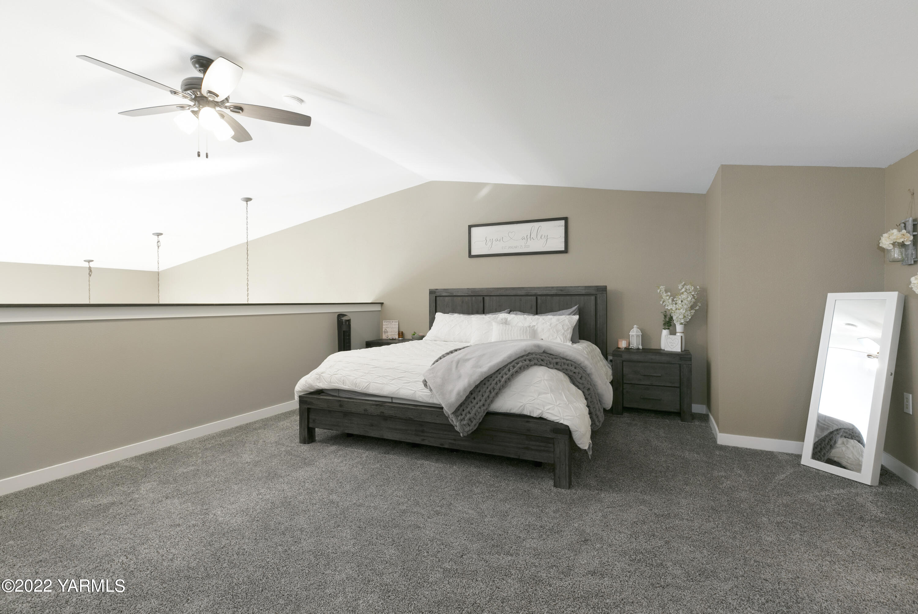 7501 Bell Road Moxee, WA 98936 - Photo 8 of 18 a bedroom with a bed and a chandelier