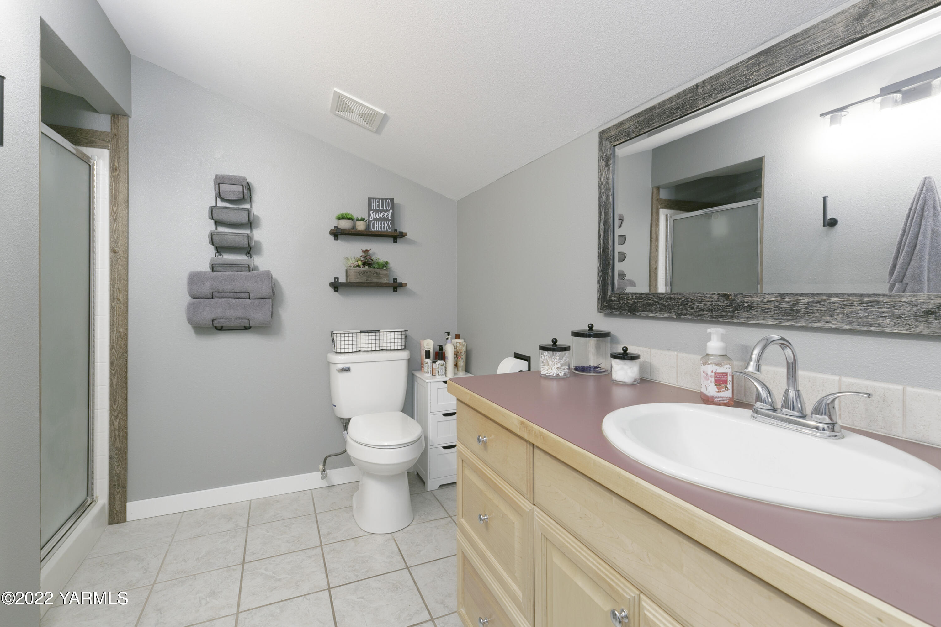 7501 Bell Road Moxee, WA 98936 - Photo 9 of 18 a bathroom with a granite countertop toilet sink and mirror