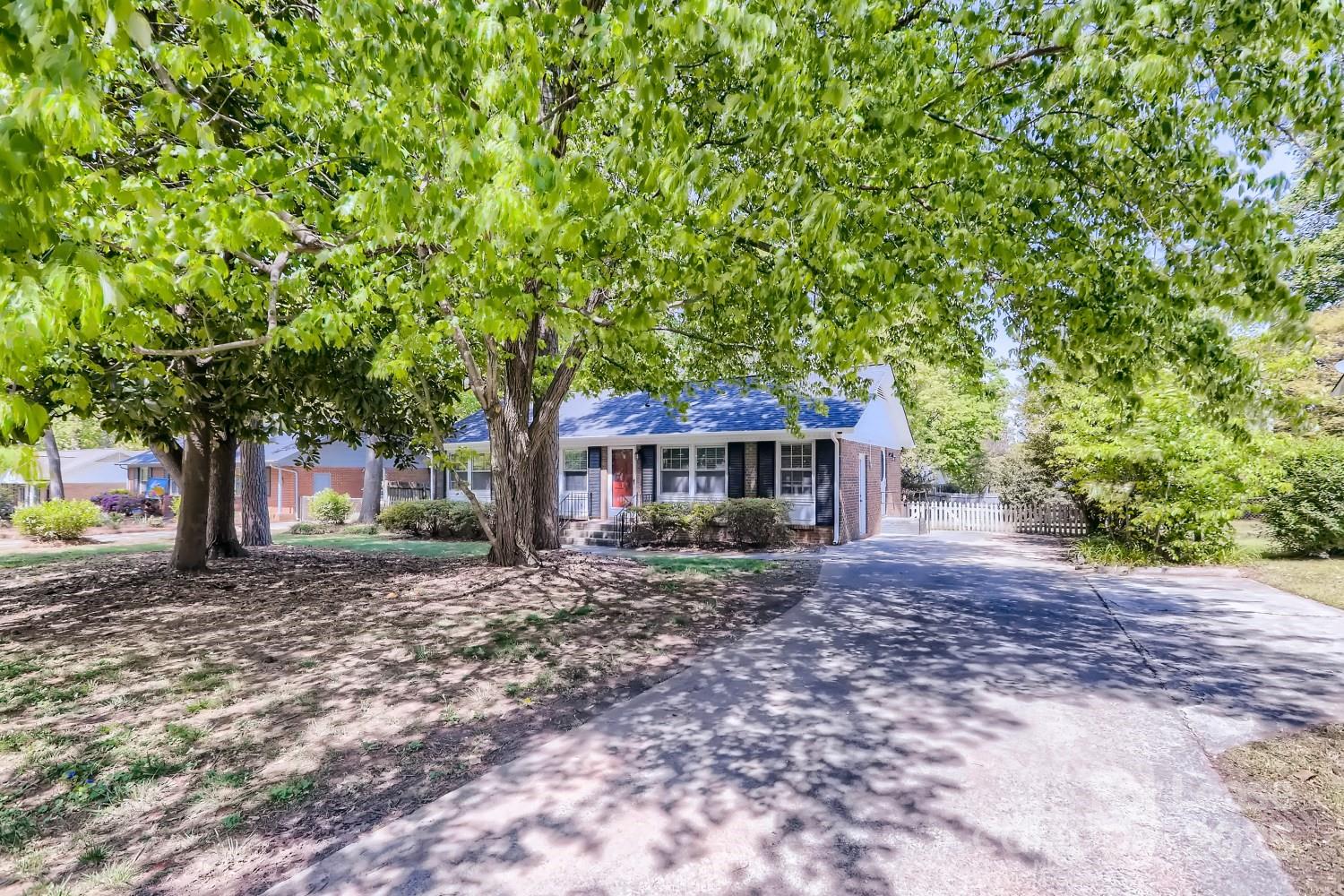 a front view of a house with a garden