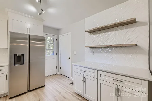 a kitchen with a refrigerator and cabinets