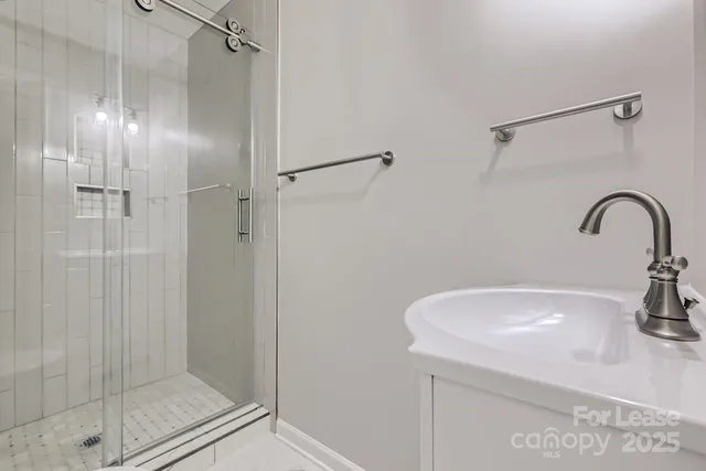 a bathroom with a sink and shower