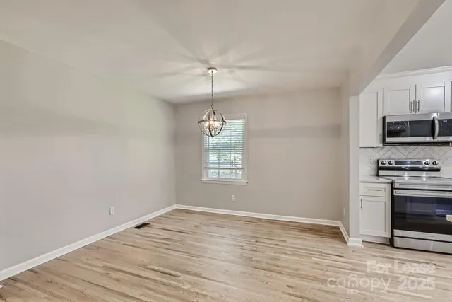 a view of a kitchen with a stove cabinets and wooden floor
