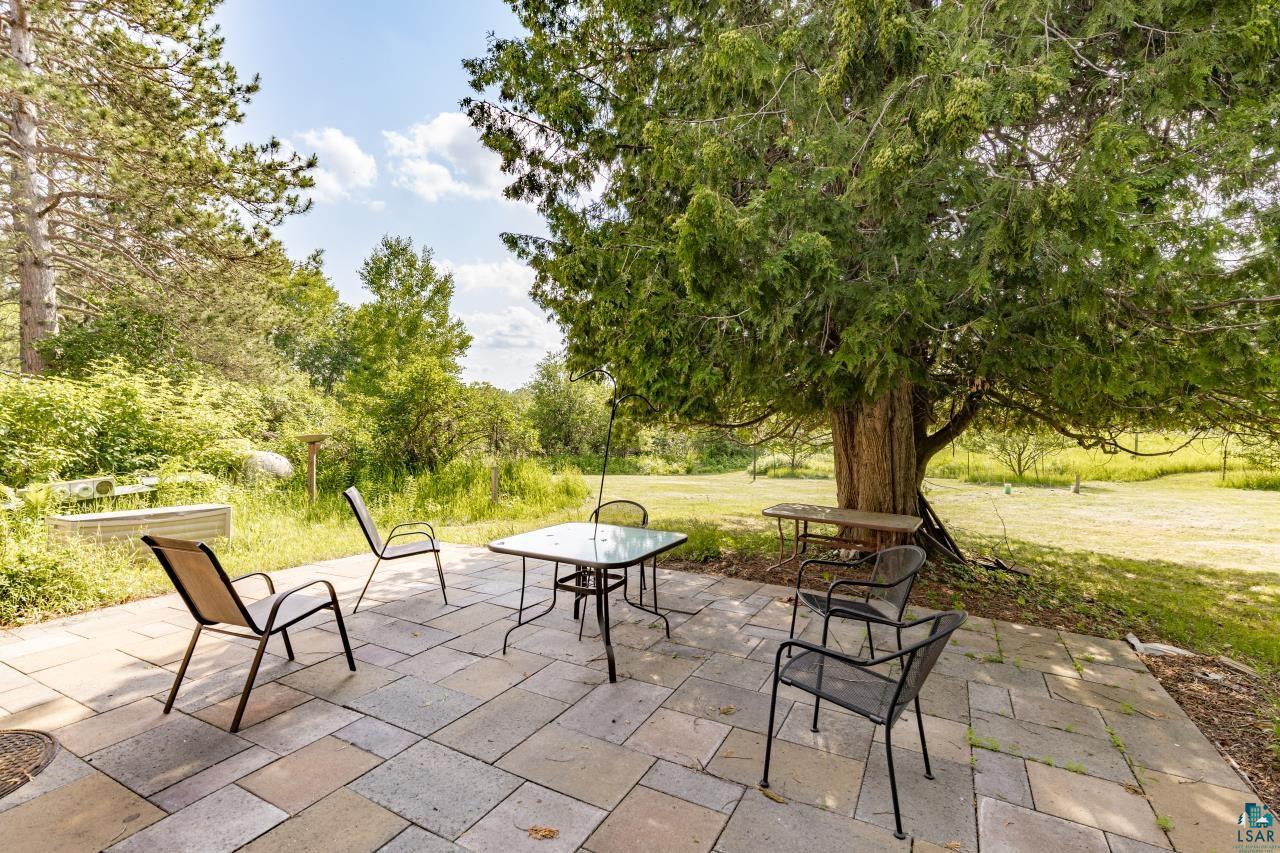 4800 Tower Road Moose Lake, MN 55767 - Photo 52 of 83 Stone paver patio featuring a large mature tree providing natural shade