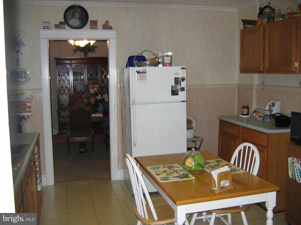 339 Front Street Lititz, PA 17543 - Photo 4 of 16 a kitchen with a refrigerator a stove a sink and a dining table with wooden floor