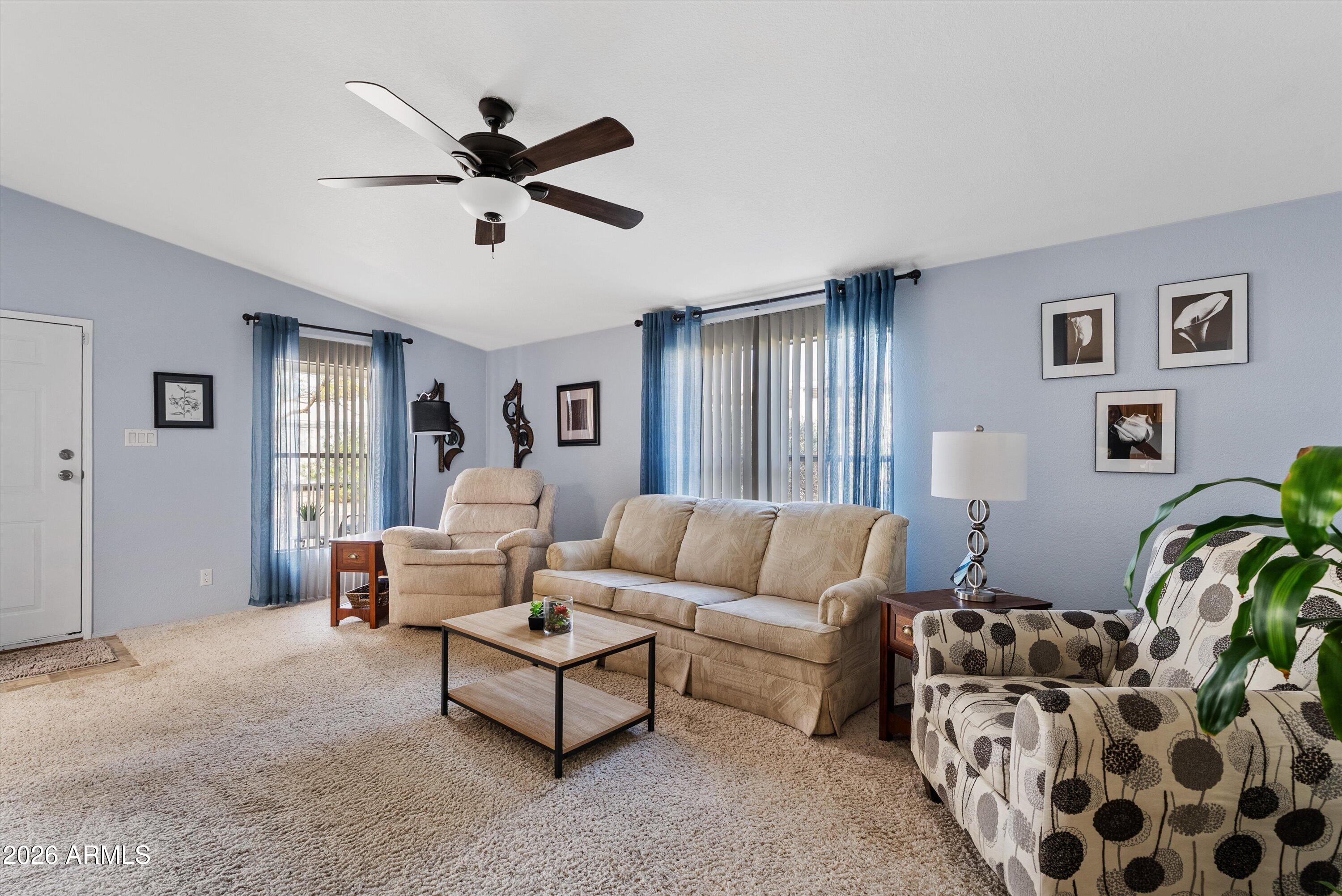 3700 South Tomahawk Road, Unit 91 Apache Junction, AZ 85119 - Photo 9 of 29 a living room with furniture and a ceiling fan