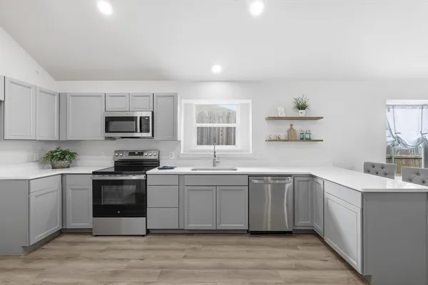 a kitchen with stainless steel appliances granite countertop a sink and stove top oven