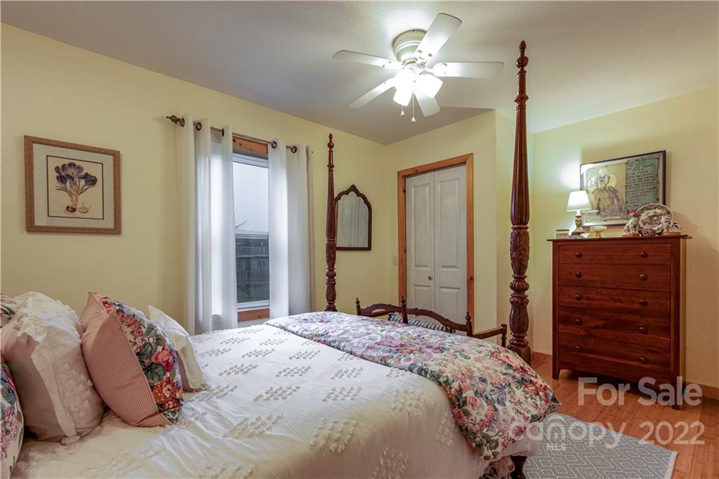 903 Davenport Road, Unit 12 Spruce Pine, NC 28777 - Photo 22 of 39 a bedroom with a bed and a chandelier