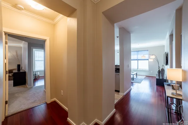 a view of a hallway view with wooden floor and furniture