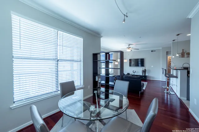 a view of a dining room with furniture and wooden floor