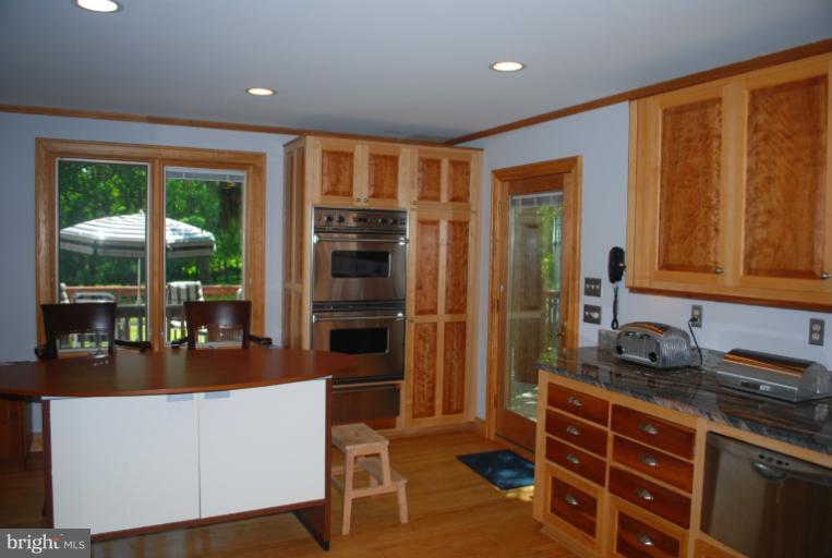 709 East Franklin Avenue Silver Spring, MD 20901 - Photo 1 of 9 a kitchen with stainless steel appliances granite countertop a stove and a refrigerator