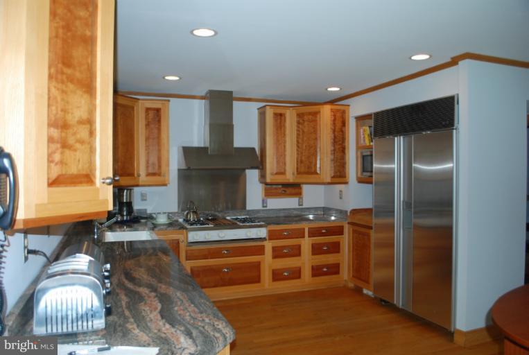 709 East Franklin Avenue Silver Spring, MD 20901 - Photo 6 of 9 a kitchen with stainless steel appliances granite countertop a stove a sink and a refrigerator