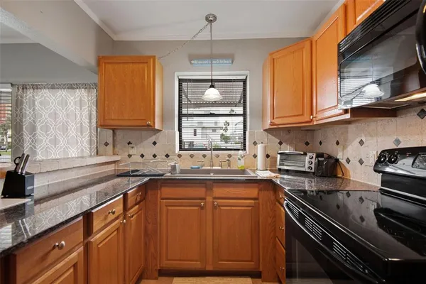 a kitchen with a sink stove top oven and cabinets