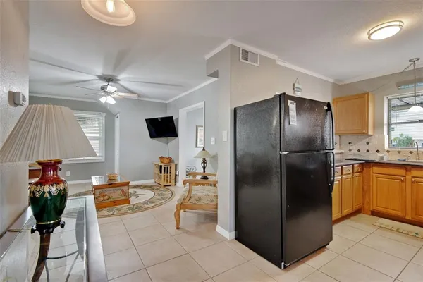 a kitchen with stainless steel appliances kitchen island granite countertop a refrigerator a stove and a sink