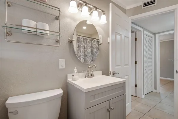 a bathroom with a sink toilet and mirror