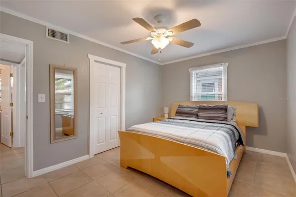 a bed sitting in a bedroom and a chandelier