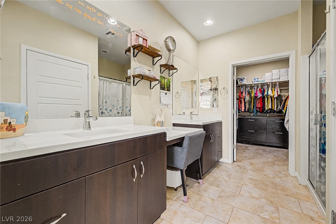 4914 East Beacon Ridge Drive Pahrump, NV 89061 - Photo 19 of 34 Double vanities and a dedicated vanity nook offer ample space in this well-appointed bathroom.