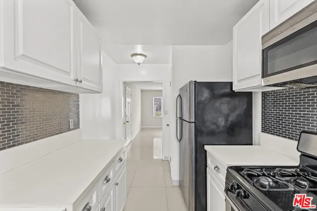a kitchen with stainless steel appliances a refrigerator and a stove