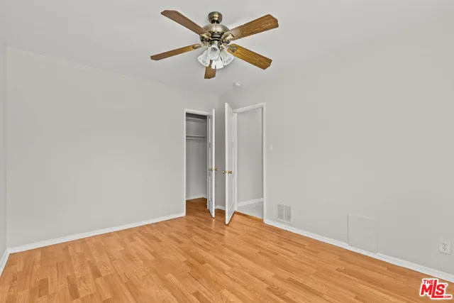 a view of a room with a sink and a chandelier fan