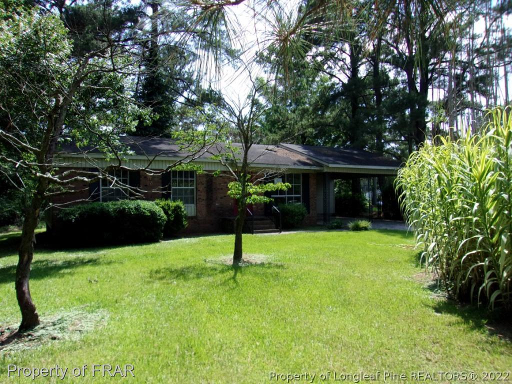 1877 H B Lewis Road Clinton, NC 28328 - Photo 1 of 10 a view of house with a backyard