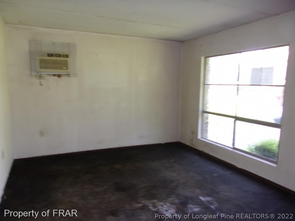 1877 H B Lewis Road Clinton, NC 28328 - Photo 2 of 10 a view of an empty room with a window