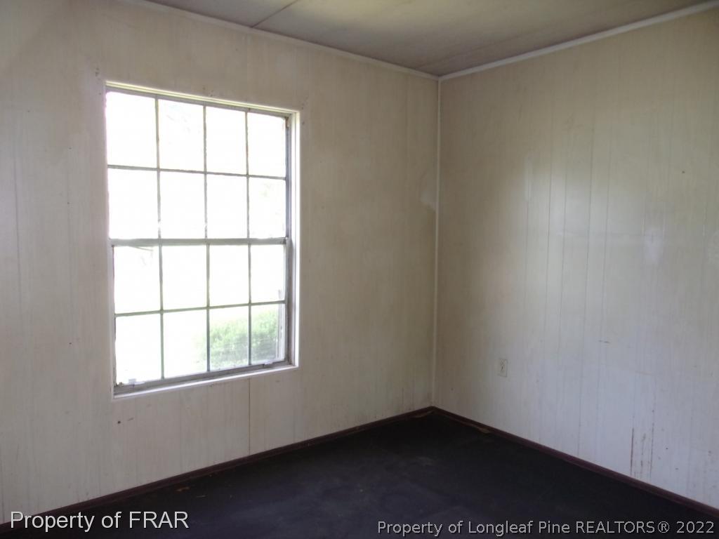 1877 H B Lewis Road Clinton, NC 28328 - Photo 5 of 10 an empty room with a window