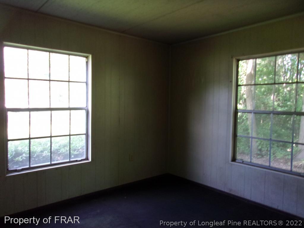 1877 H B Lewis Road Clinton, NC 28328 - Photo 8 of 10 a view of an empty room with a window
