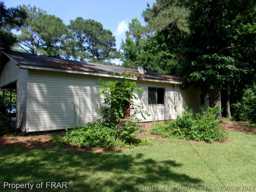 1877 H B Lewis Road Clinton, NC 28328 - Photo 10 of 10 a front view of a house with garden
