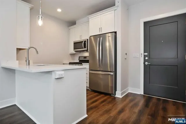 a kitchen with stainless steel appliances a refrigerator and a sink