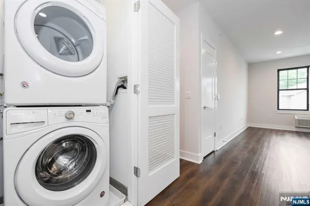 a view of a hallway with washer and dryer
