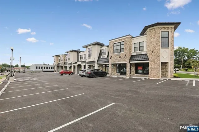 a front view of a building with parking space