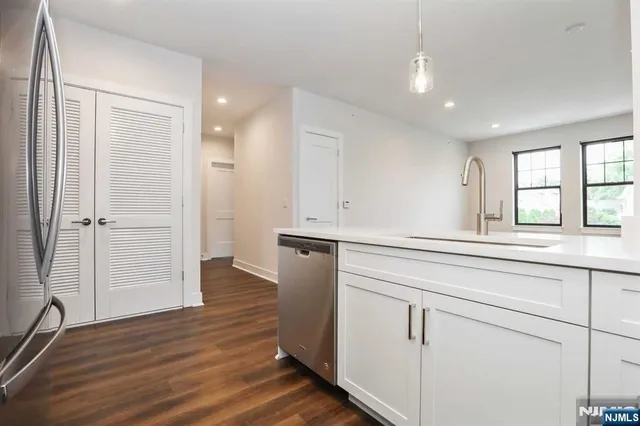 wooden floor with white cabinets and wooden floor