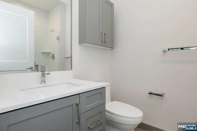 a bathroom with a sink toilet and vanity