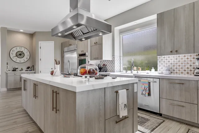 a kitchen with a sink stove and cabinets