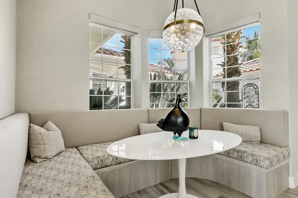 a view of a dining room with furniture wooden floor and chandelier