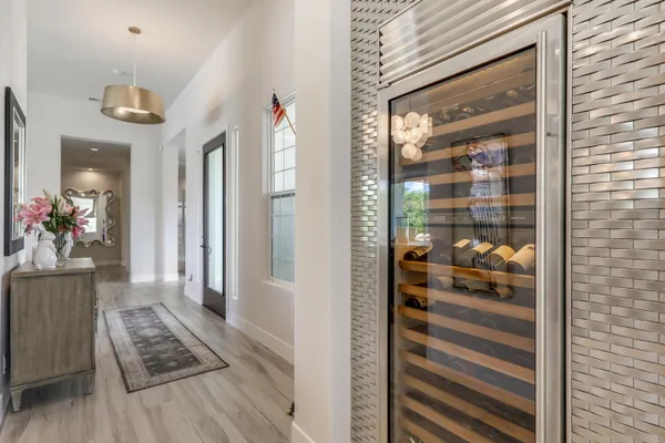 a view of a hallway and a dining room with wooden floor