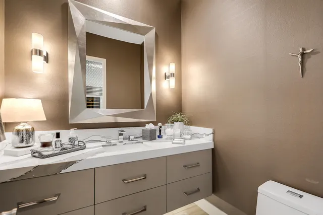 a bathroom with a toilet sink and mirror