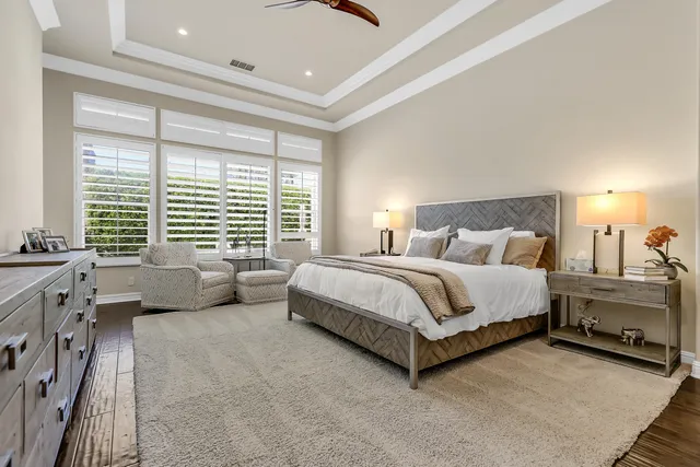 a spacious bedroom with a bed and a couch