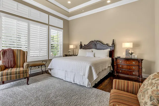 a bedroom with bed couch and window