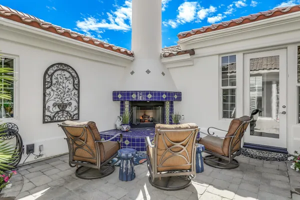 a view of a patio with table and chairs